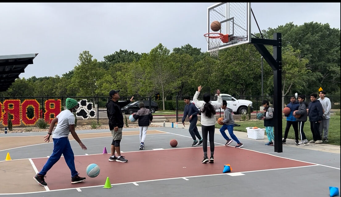 Players practicing passing and catching in a drill line
