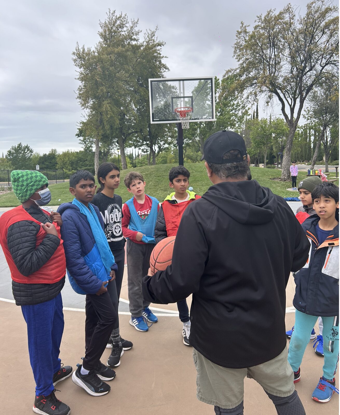Coach talking with a group of young players in a huddle
